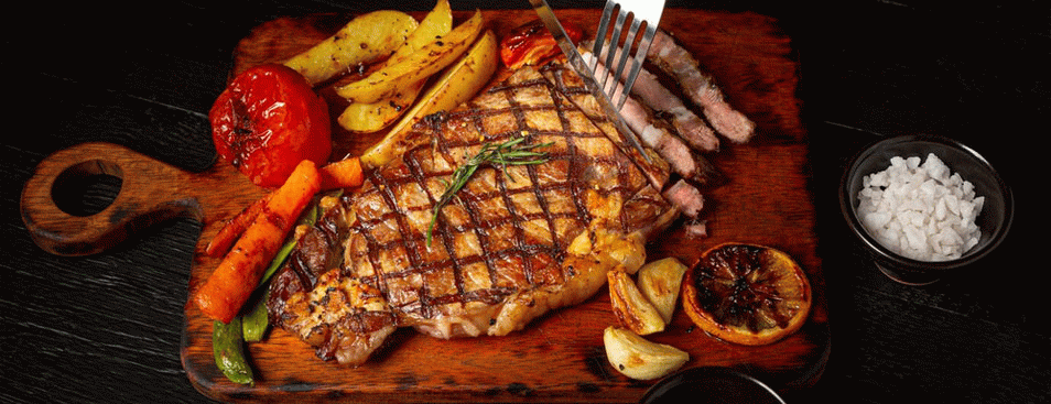 Grilled Beef Steak on the Dark Wooden Surface
